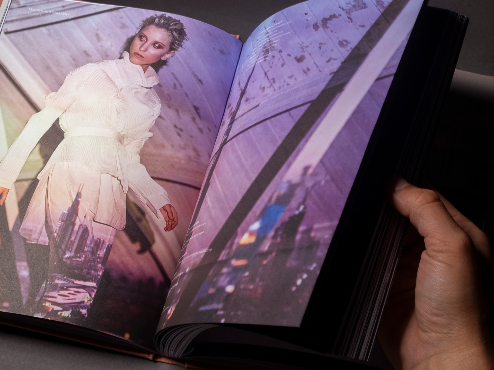 Printed spread from the Accouter Four annual showcasing one of the images of a model with a skyline projected across her body