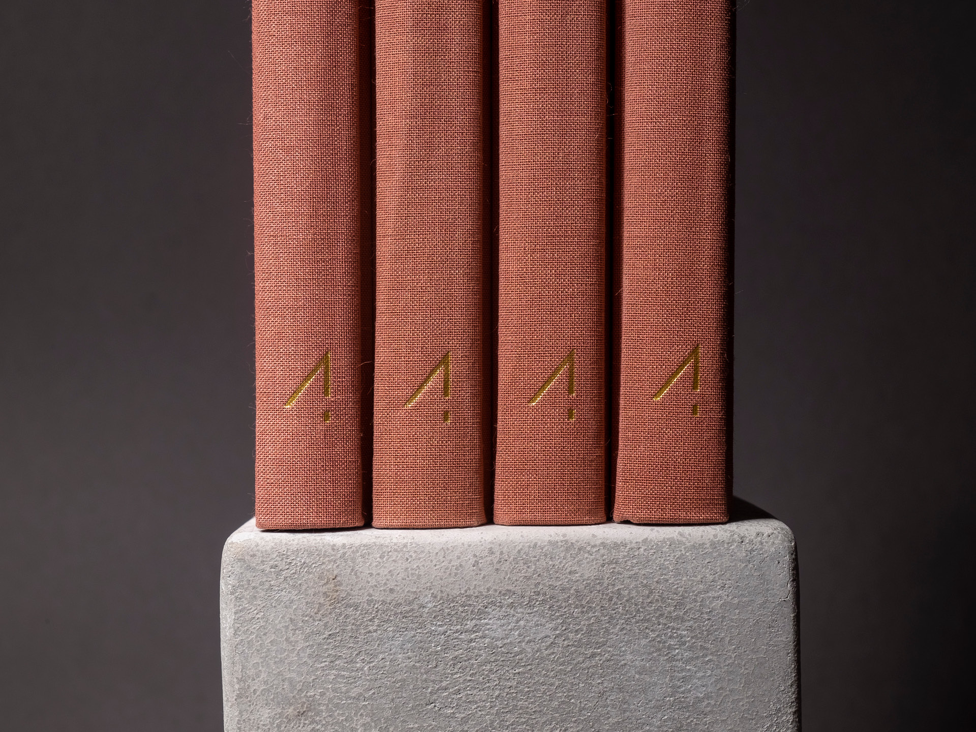 Four copper foiled logos on canvas spine