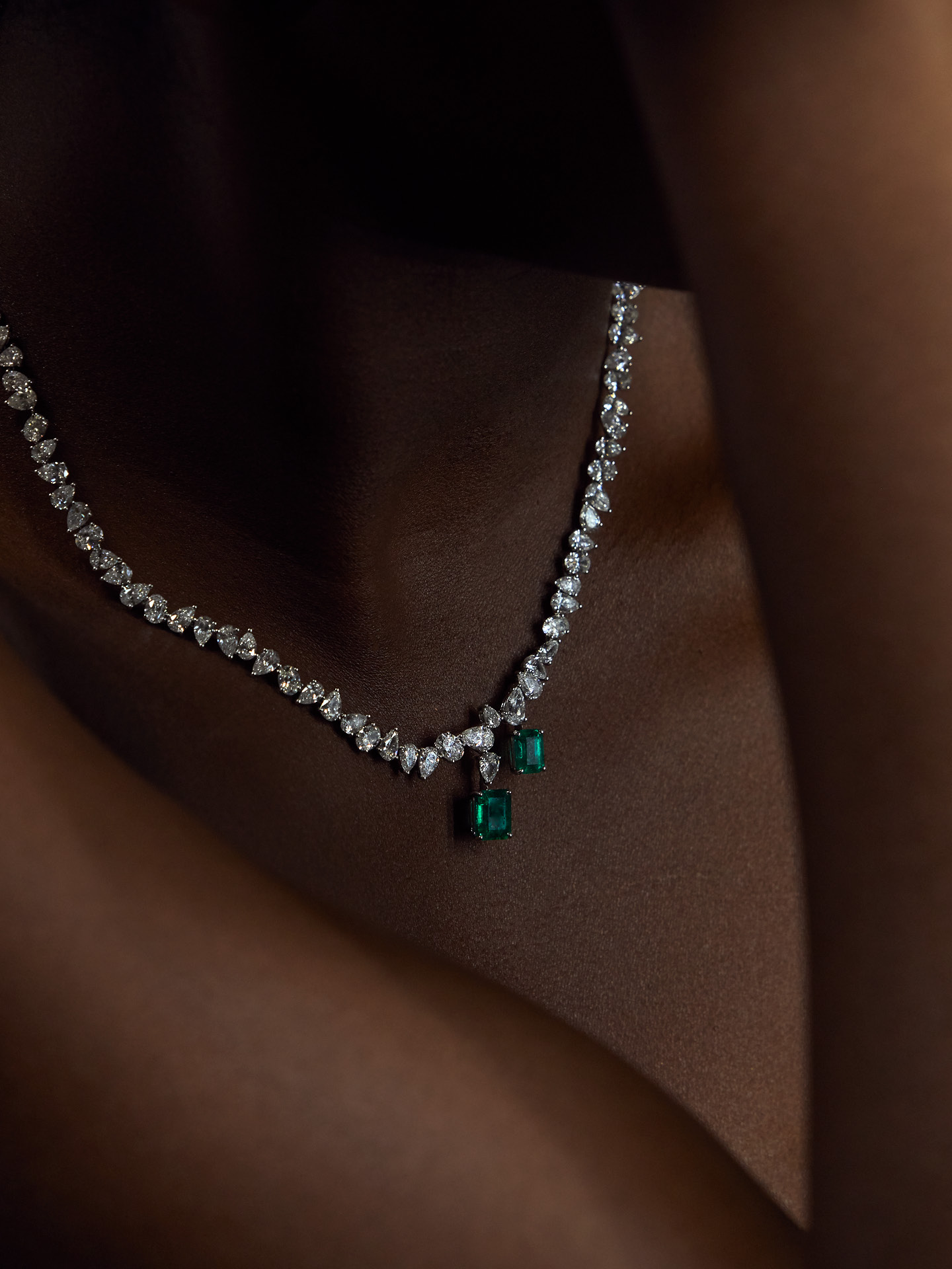 Detailed crop of a black woman wearing a William and Son silver diamond necklace