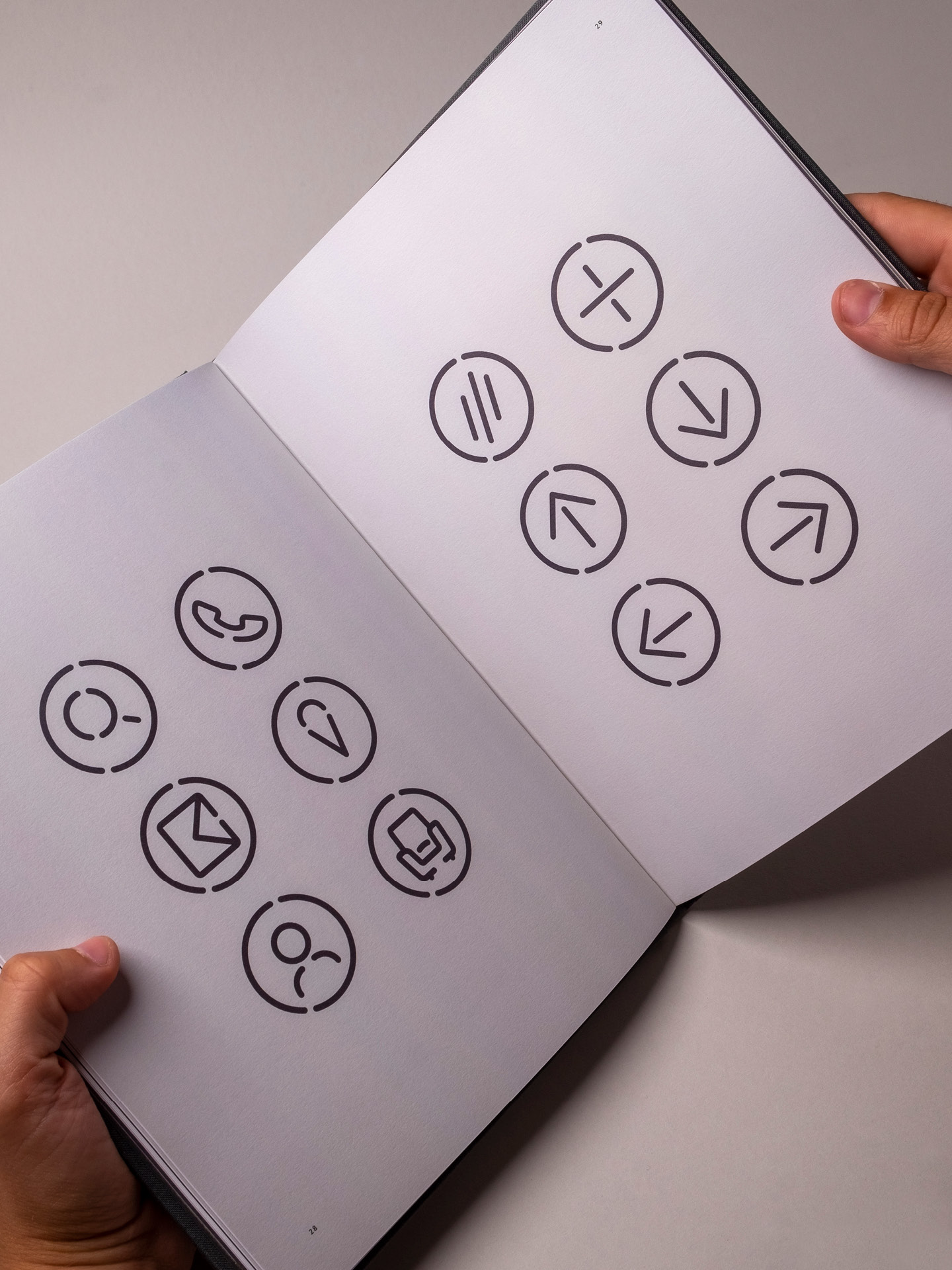A printed spread from the brand guidelines document showcasing the custom made icons used by the brands communication