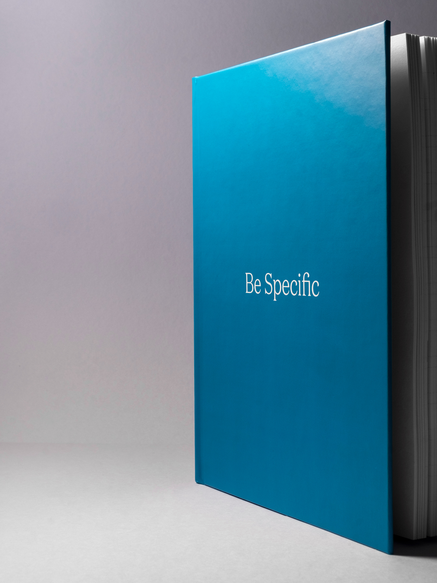 The cover of the Be Specific book set in white type on a hardback blue cover