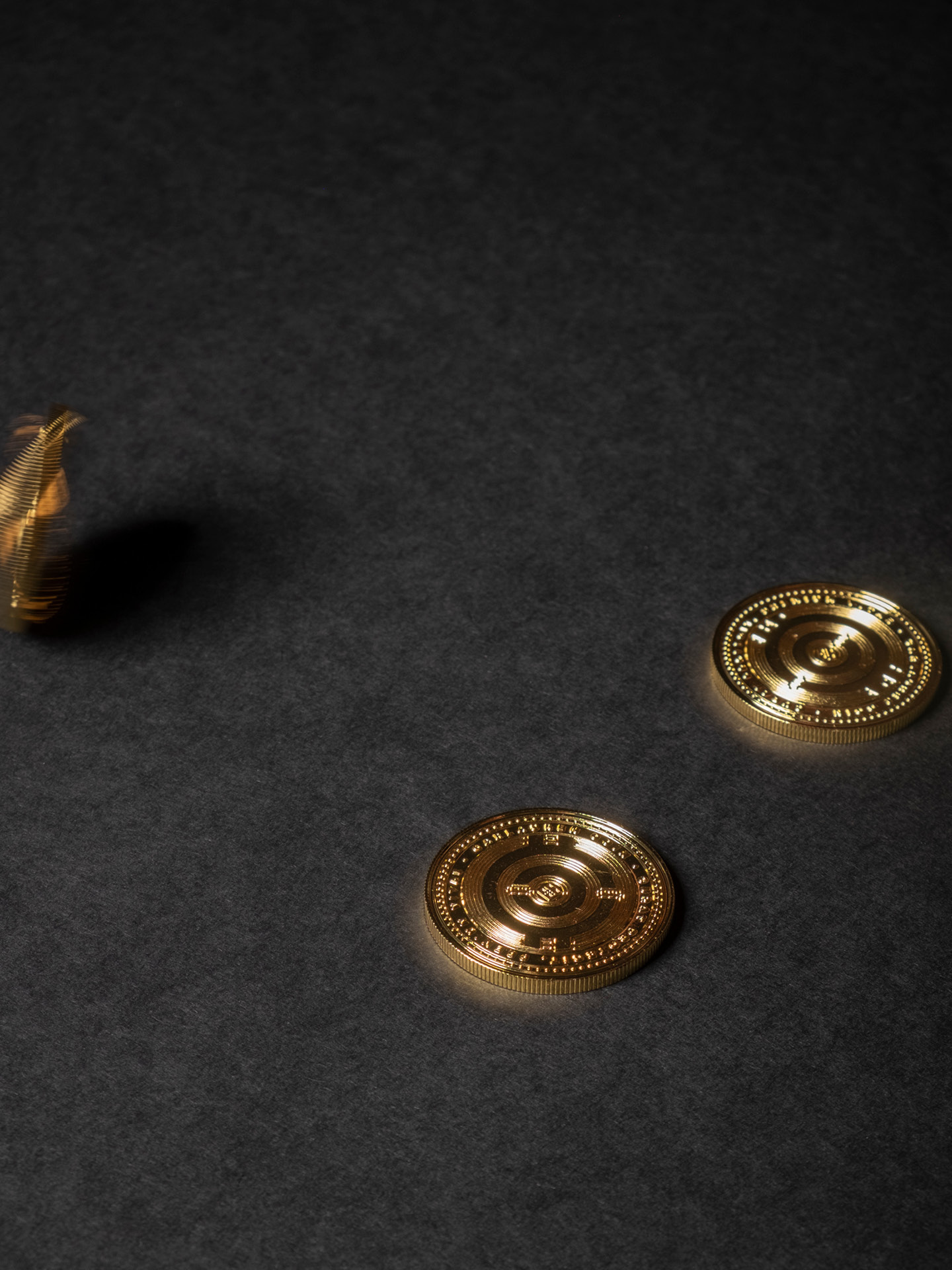 Three golden coins made for the digital current promoted by the brand