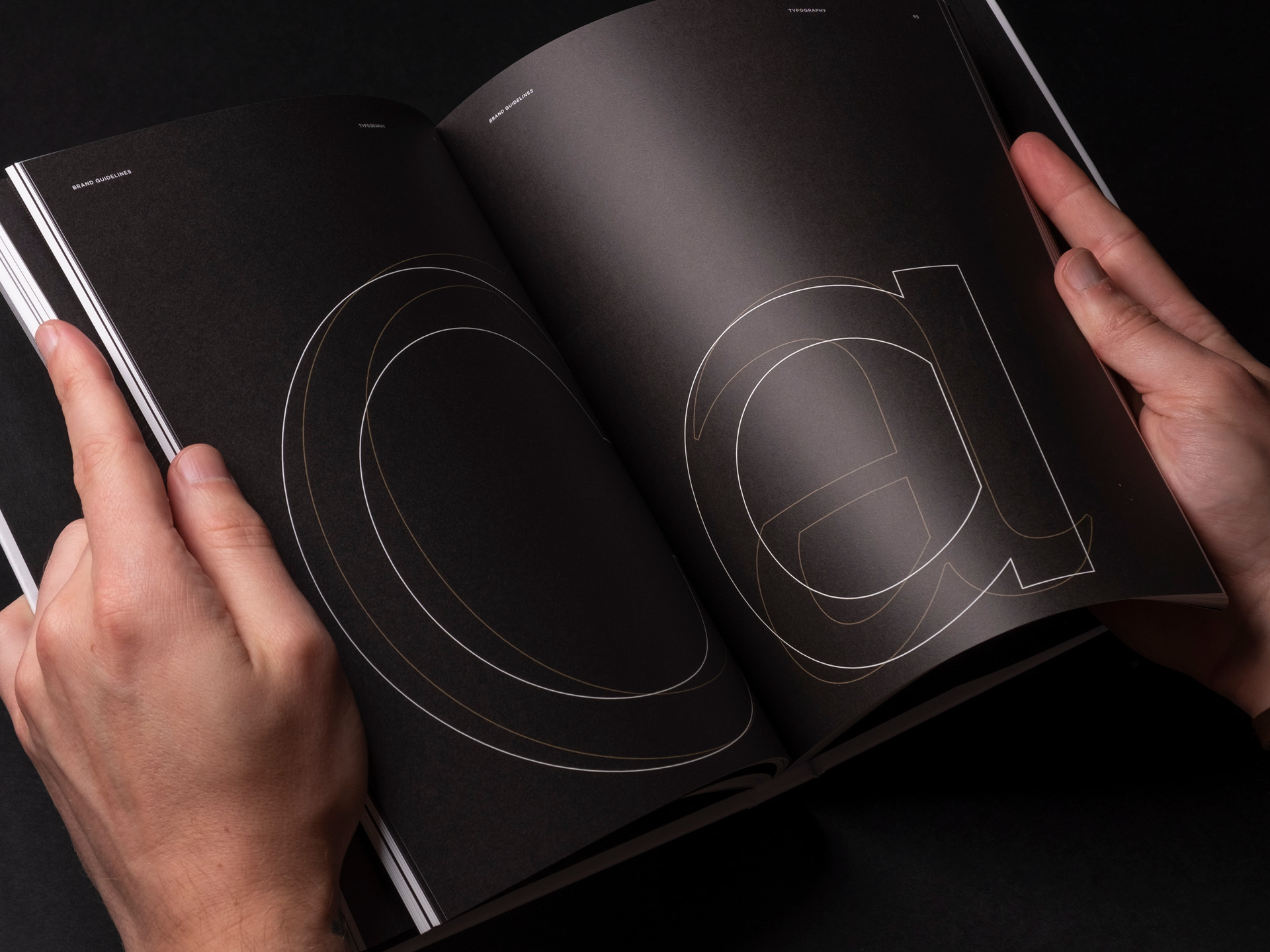 A printed spread from the Carlauren guidelines detailing the overlapping characters of the two brand typefaces