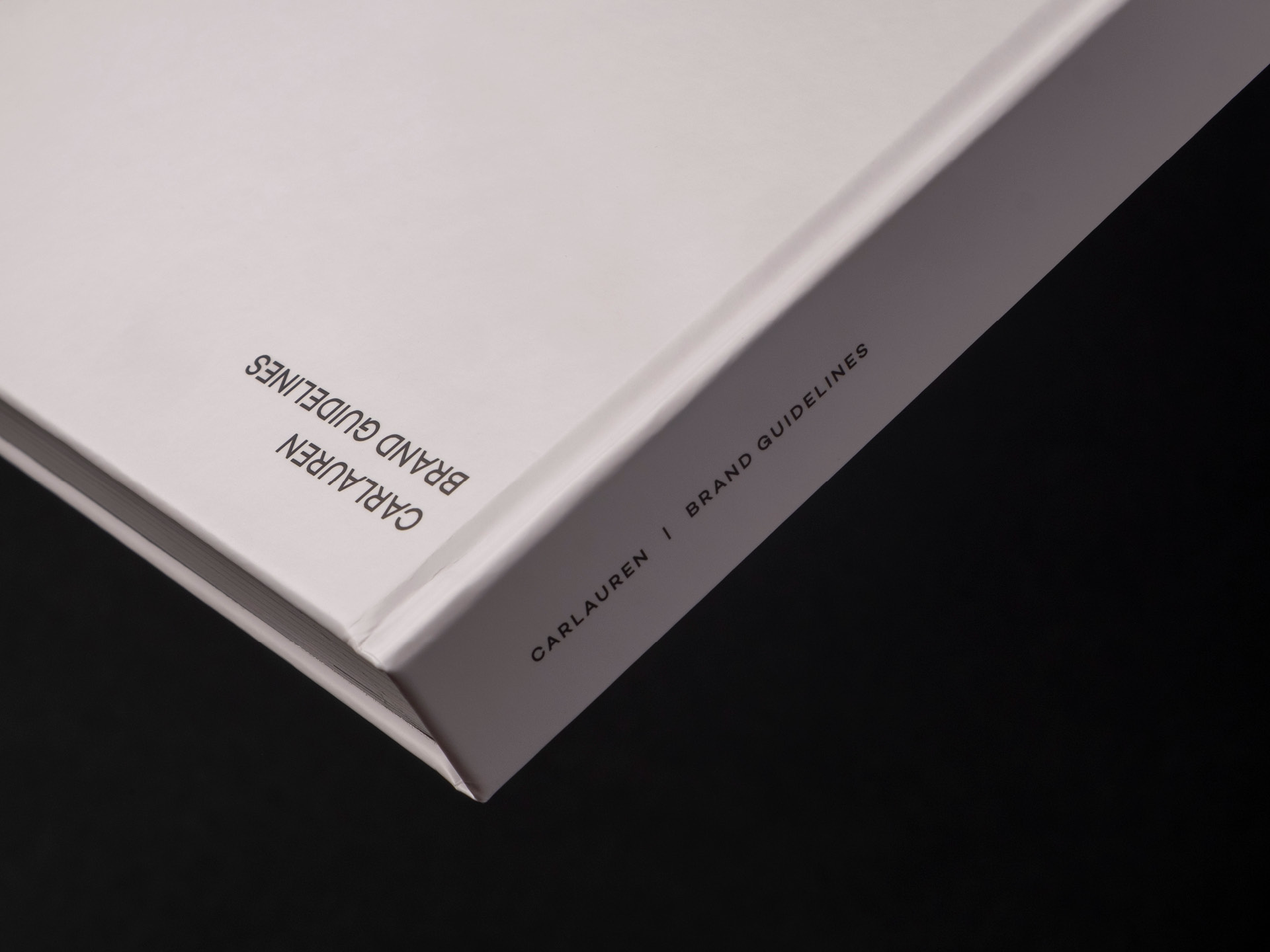 A detailed shot of the Carlauren brand guidelines cover and spine